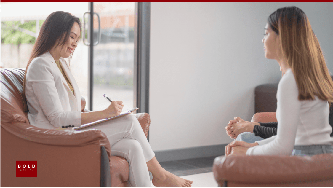 A person in a therapy session looking contemplative and empowered, representing deep healing beyond symptom management.