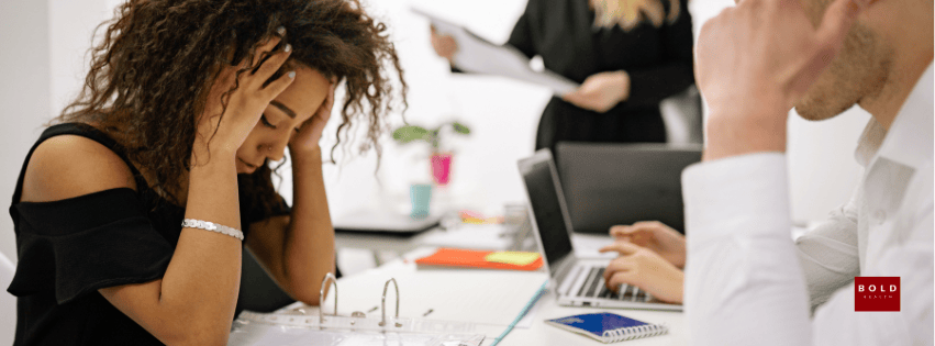 Person experiencing stress or anxiety, possibly related to OCD, in a professional setting.