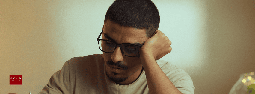 Man with glasses looking worried, representing OCD myths and misconceptions.