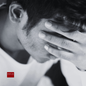 Person holding head in stress or anxiety, promoting mental health awareness and relief strategies.