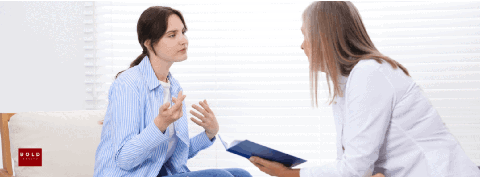 Therapist and patient having a counseling session in a bright, professional setting.
