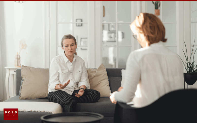 Therapist and patient having a therapy session in a bright, modern office setting.