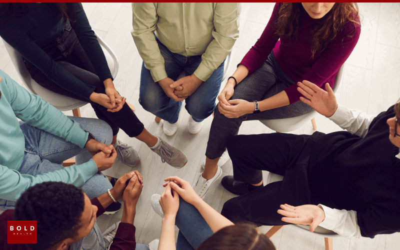 People in a support group meeting for addiction recovery at Bold Health, sitting in a circle and sharing experiences.