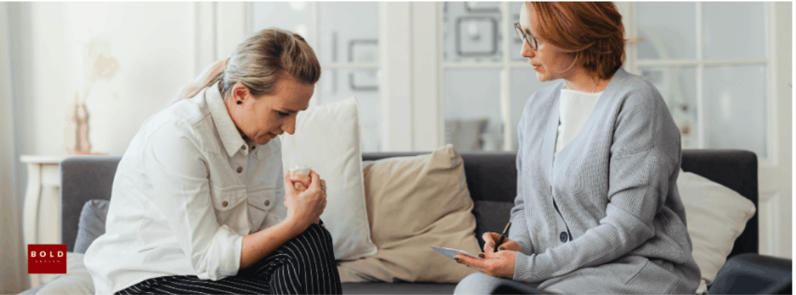 Two women in a therapy session discussing depression recovery in a comfortable setting.