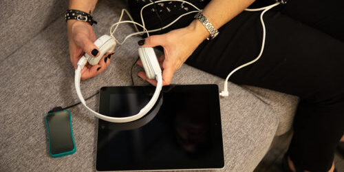 A patient with headphones, an iOM heartrate sensor and a tablet using technology from biofeedback company unyte