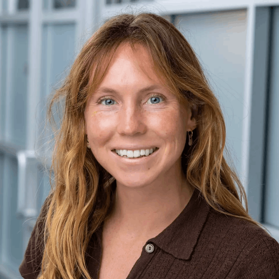 Smiling woman with red hair in a professional setting, representing Bold Health team member.